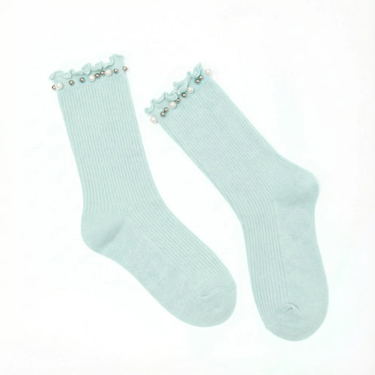 A pair of light duck egg blue ribbed crew socks with decorative ruffled trim and small pearl-like beads at the top, displayed on a clean white background.