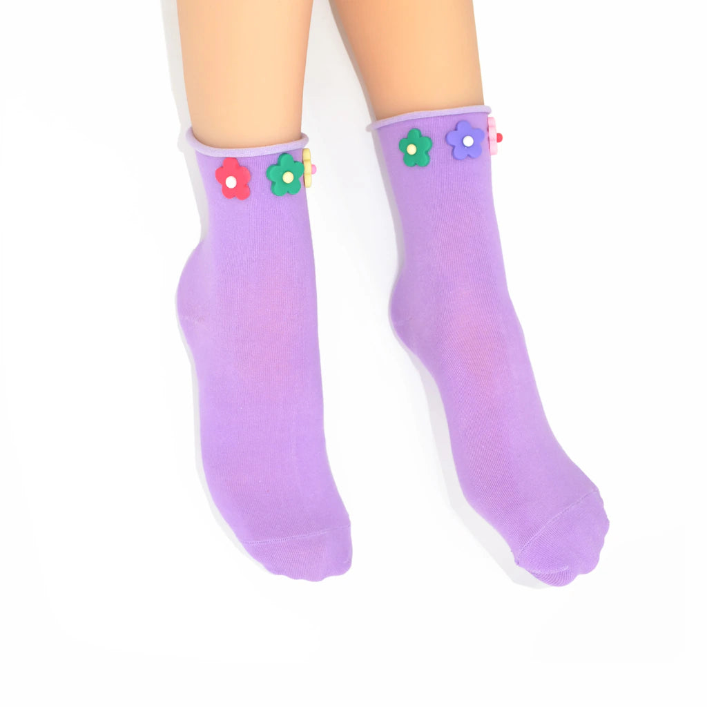 Purple socks with flower designs on a white background