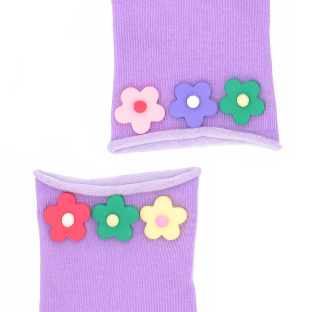 Purple socks with colorful flower decorations on a white background