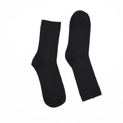 A pair of black socks displayed flat against a solid white background.