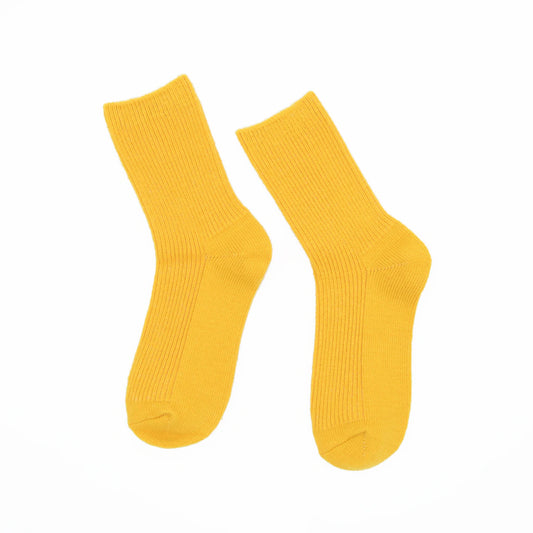 A pair of bright yellow ribbed crew socks shown flat against a solid white background.