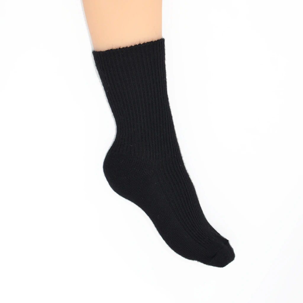 A single black ribbed crew sock shown on a foot against a plain white background.