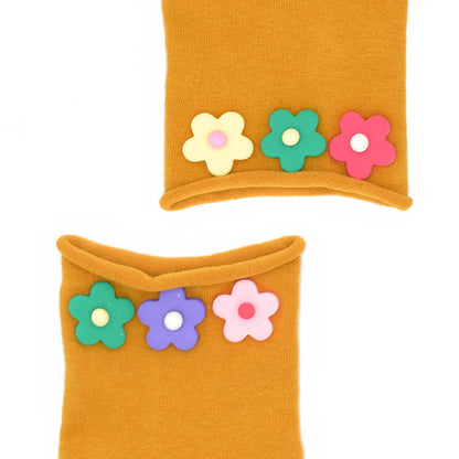 Two mustard yellow socks with colorful flower decorations on a white background