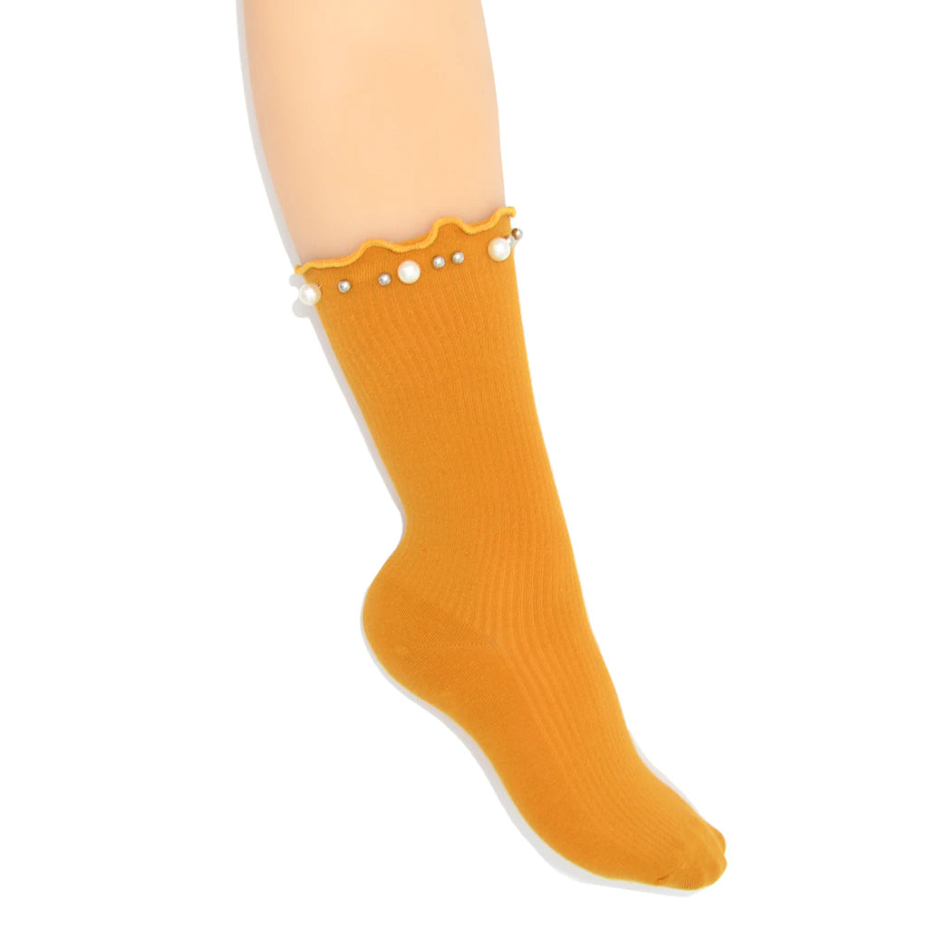 Mustard yellow sock with pearl details on a white background