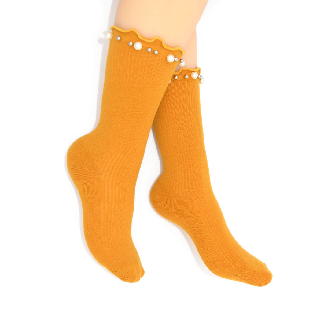 Yellow knee-high socks with decorative trim on a white background