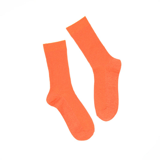 Pair of orange socks on a white background