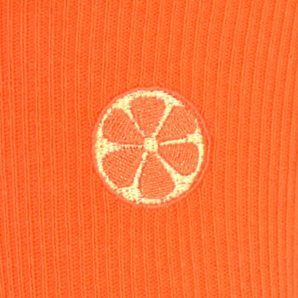 Embroidered orange on a ribbed knit orange fabric background