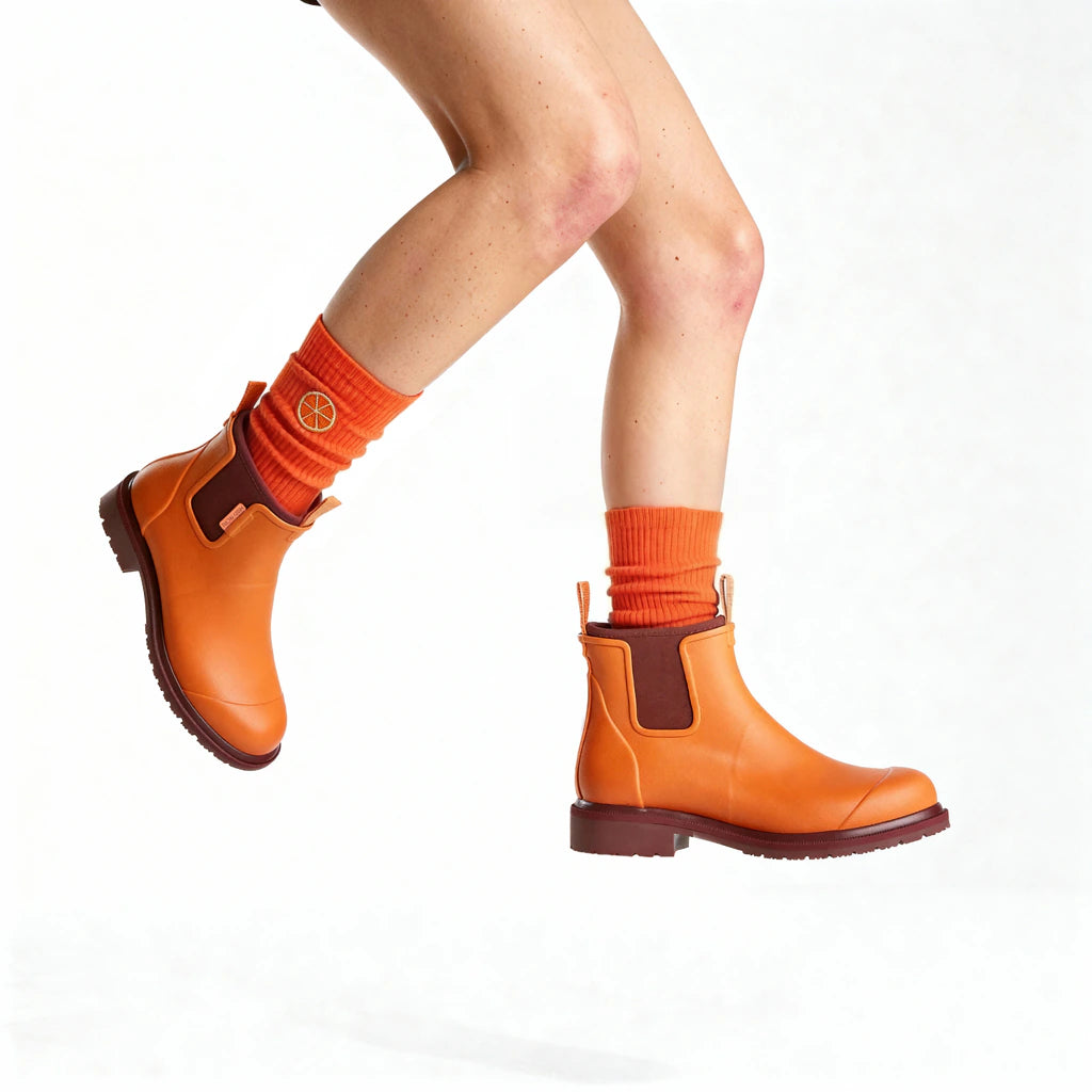 Orange boots and socks on a white background