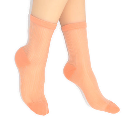 Peach-colored socks worn by a person on a white background