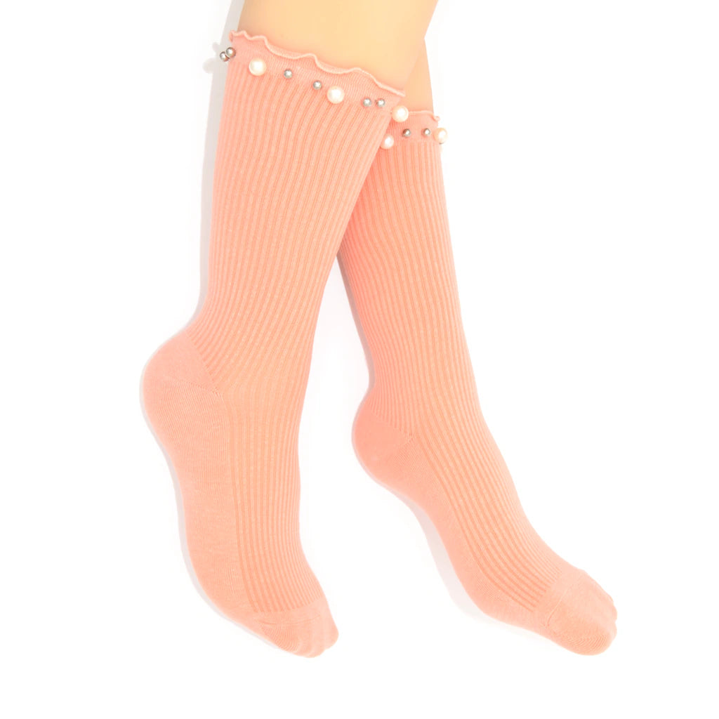 Pink socks with embellished pearls on a white background