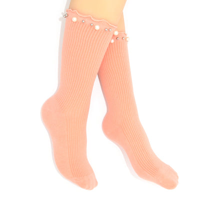 Pink socks with embellished pearls on a white background