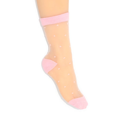 Sheer peach socks with pink accents and white polka dots on a white background