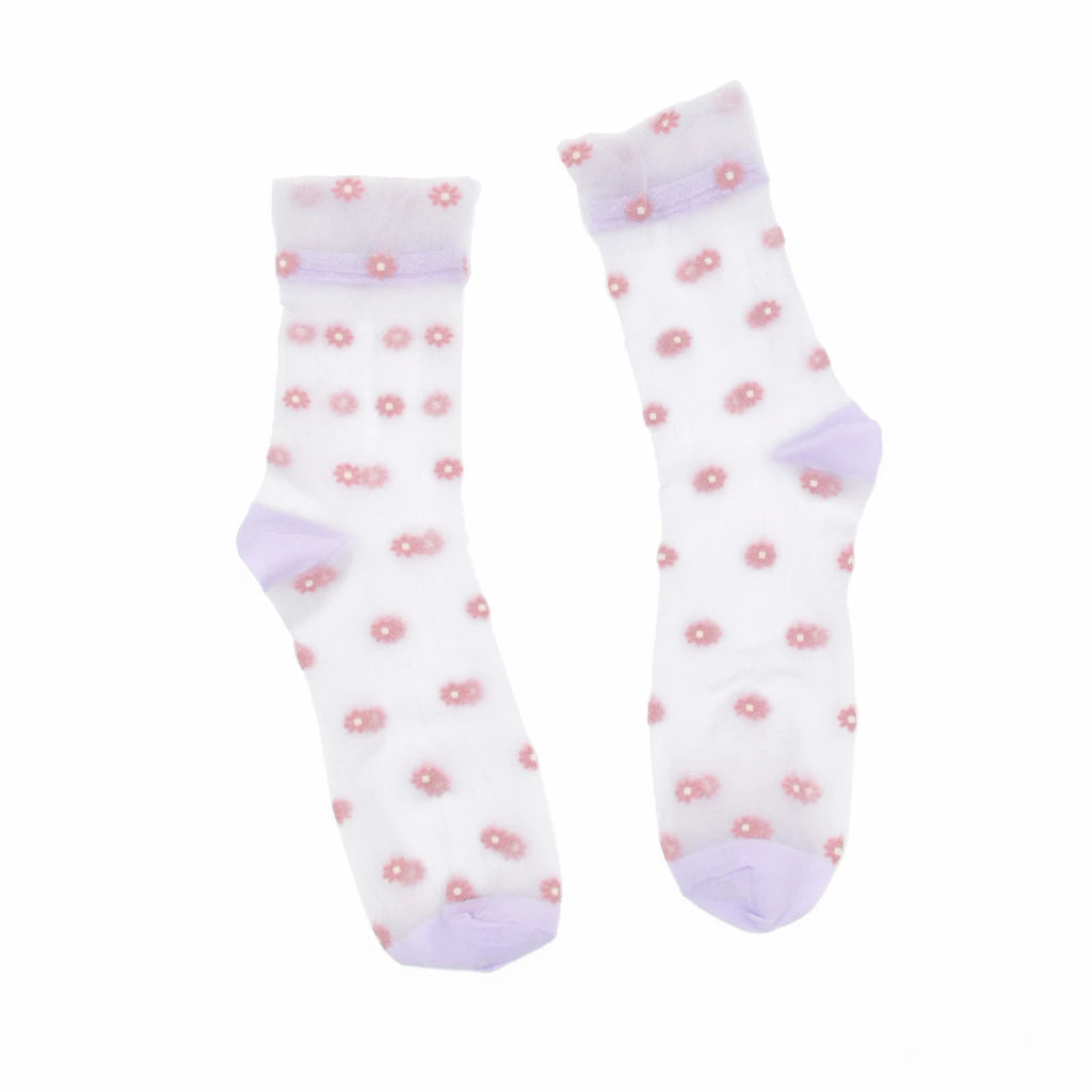 A pair of white sheer mesh crew socks decorated with small pink flower motifs and light purple cuffs, heels, and toes, displayed against a solid white background.