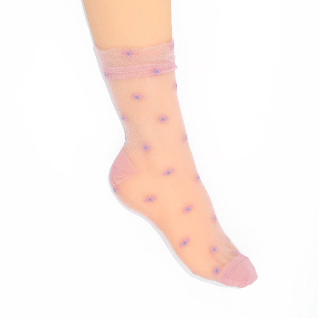 A single ankle-length sheer pink sock with small purple floral motifs, shown on a foot against a plain white background.