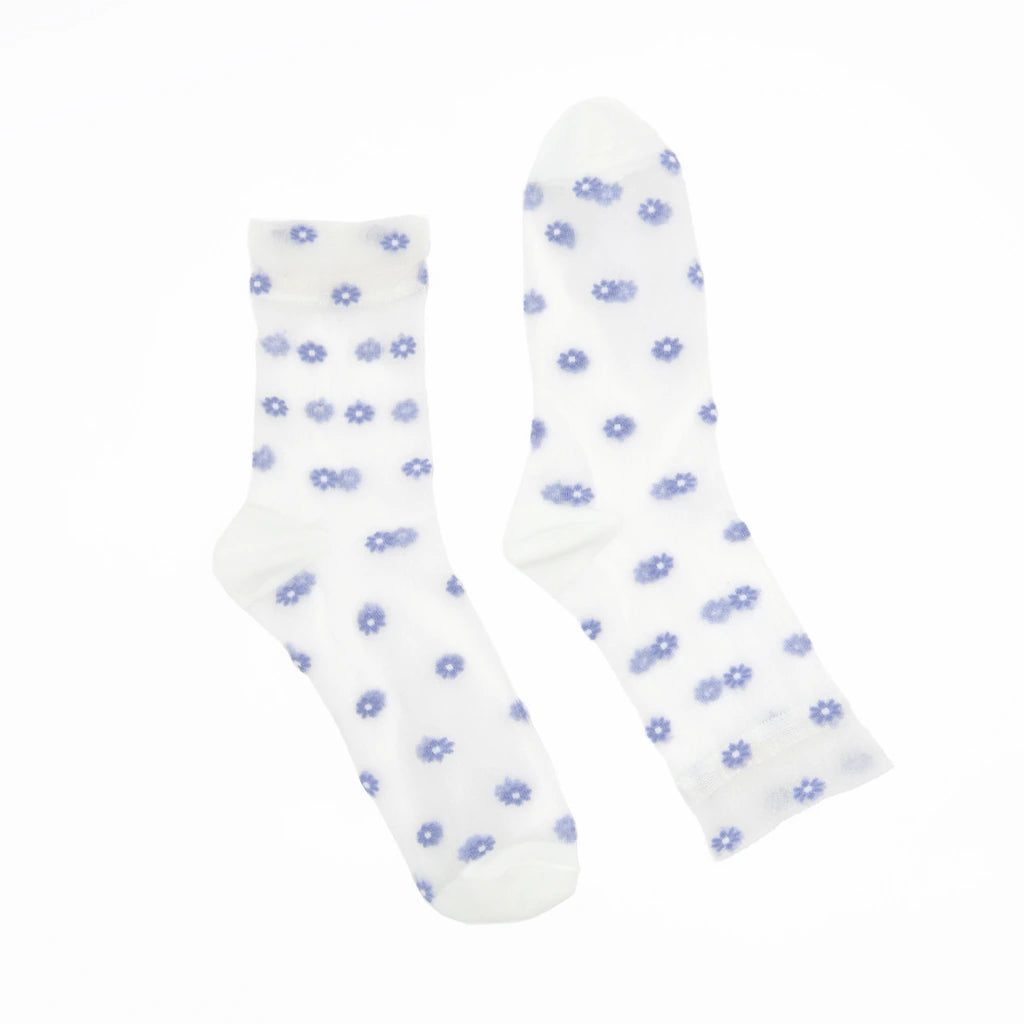 A pair of white crew socks with a small blue daisy pattern, displayed against a solid white background.