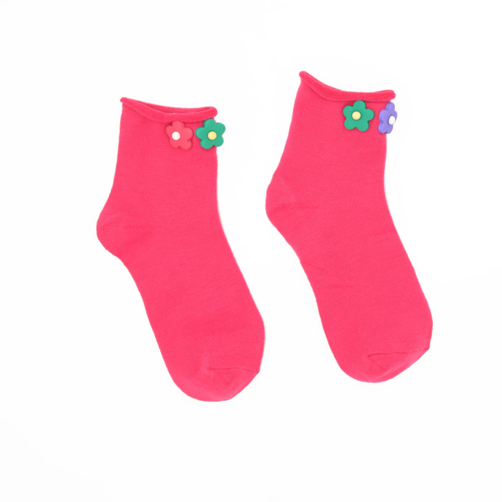 Pair of pink socks with flower decorations on a white background