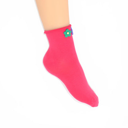 Pink sock with a colorful flower design on a white background