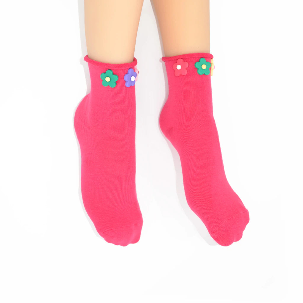 Pink socks with flower designs on a white background