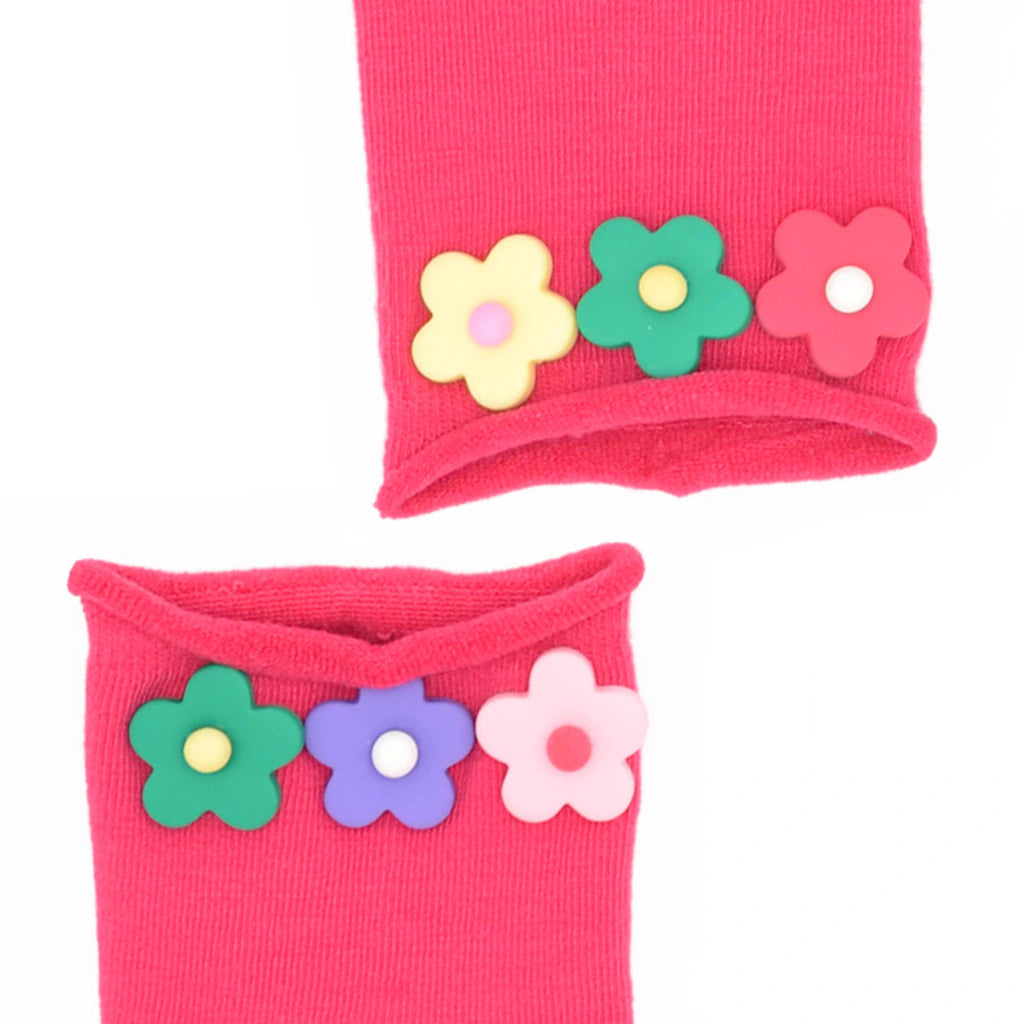 Pink wristbands with colorful flower designs on a white background
