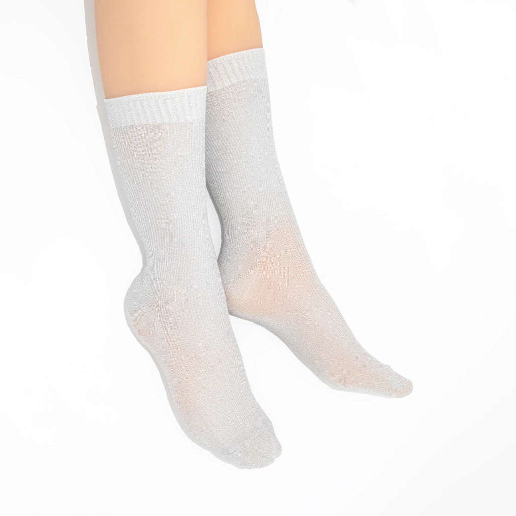 Silver socks worn on a white background