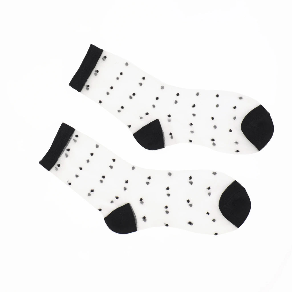 A pair of sheer  socks with small black polka dots, black cuffs, and black heels, displayed on a clean white background.