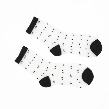 A pair of sheer  socks with small black polka dots, black cuffs, and black heels, displayed on a clean white background.