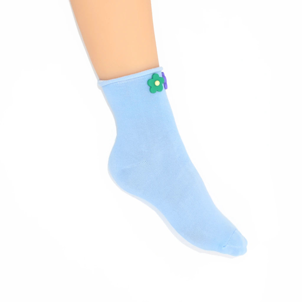 Light blue sock with a flower design on a white background