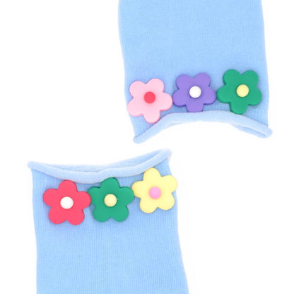 Light blue socks with colorful flower decorations on a white background