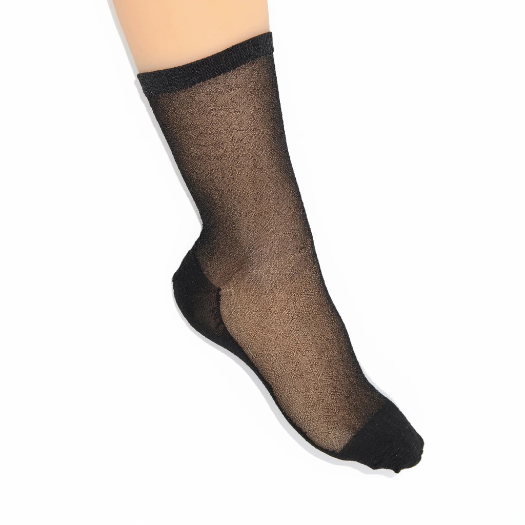 Tiffany Matte Black sheer sock worn on foot, showing the transparent black mesh and dark cuff.
