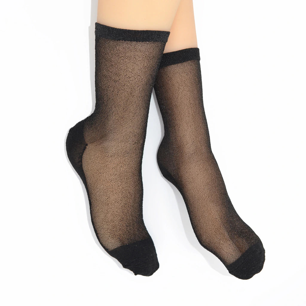 Pair of Tiffany Matte Black sheer socks worn on feet, showing the sheer black finish with darker toe and heel.