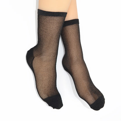 Pair of Tiffany Matte Black sheer socks worn on feet, showing the sheer black finish with darker toe and heel.