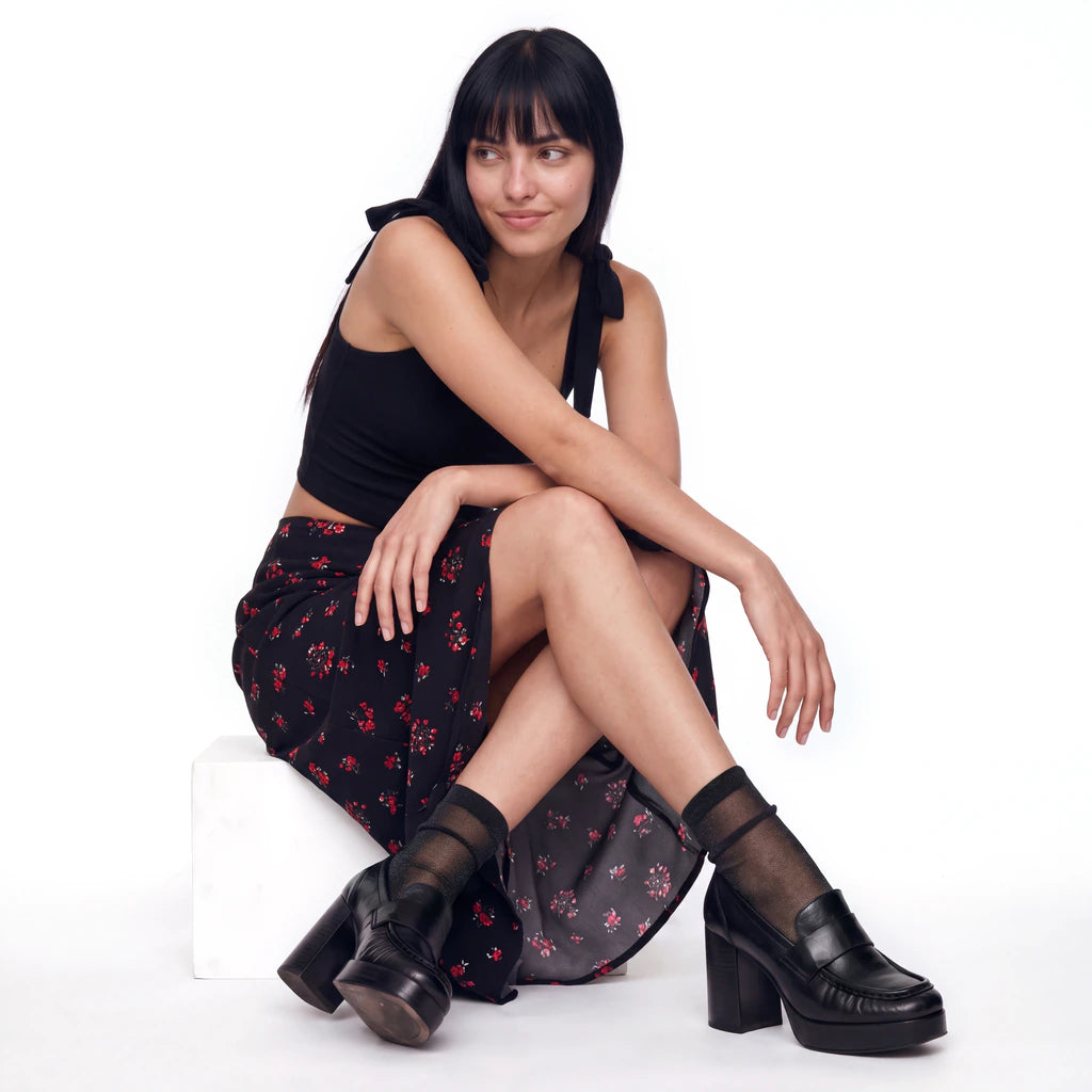 Model wearing Tiffany Matte Black sheer socks with black platform loafers and a floral midi skirt.