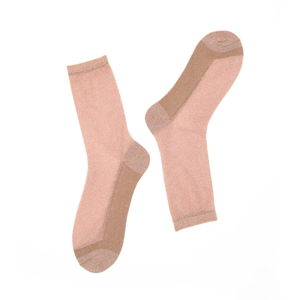 Pair of rose gold socks on a white background