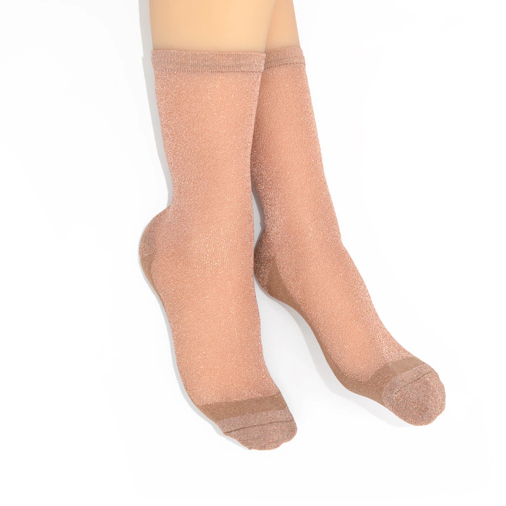 Sheer rose gold socks on a white background
