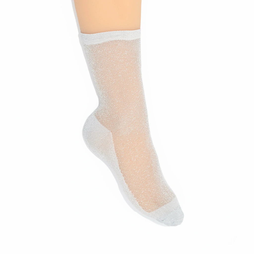 Sheer silver sock on a leg against a white background