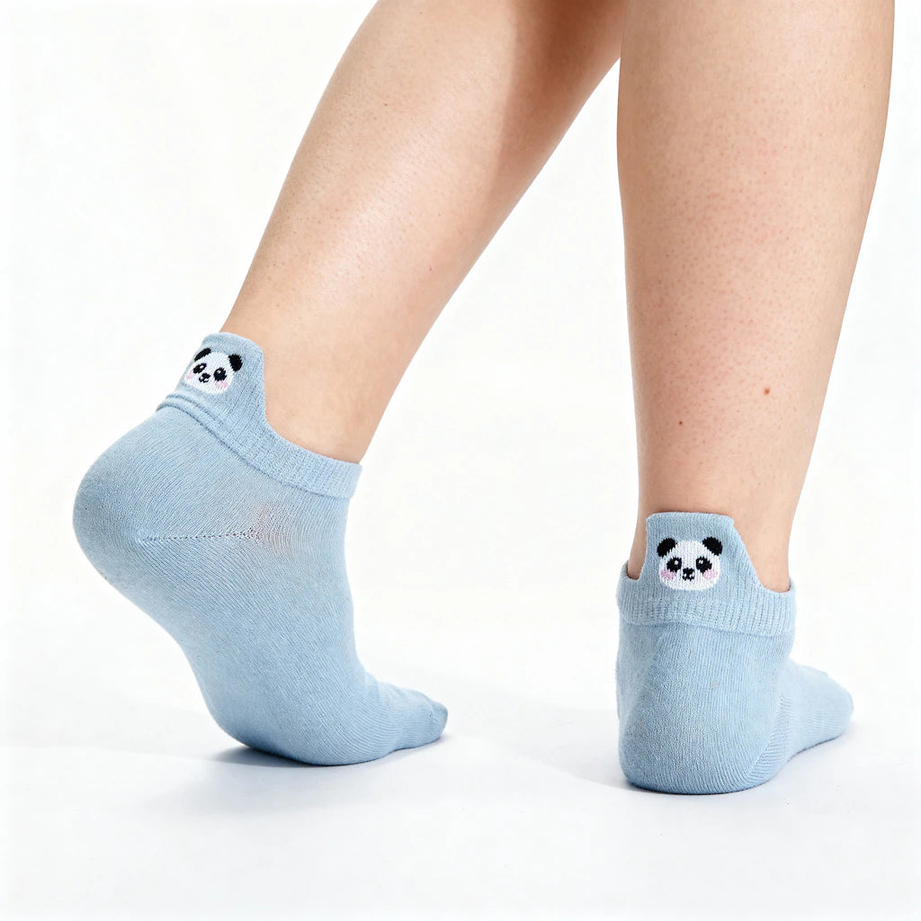 Light blue no show socks with panda faces on a white background