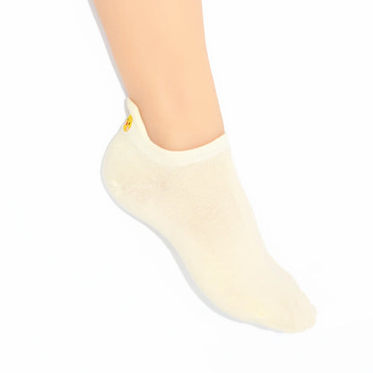A leg showing a soft yellow no show sock with chicken embroidered motif design