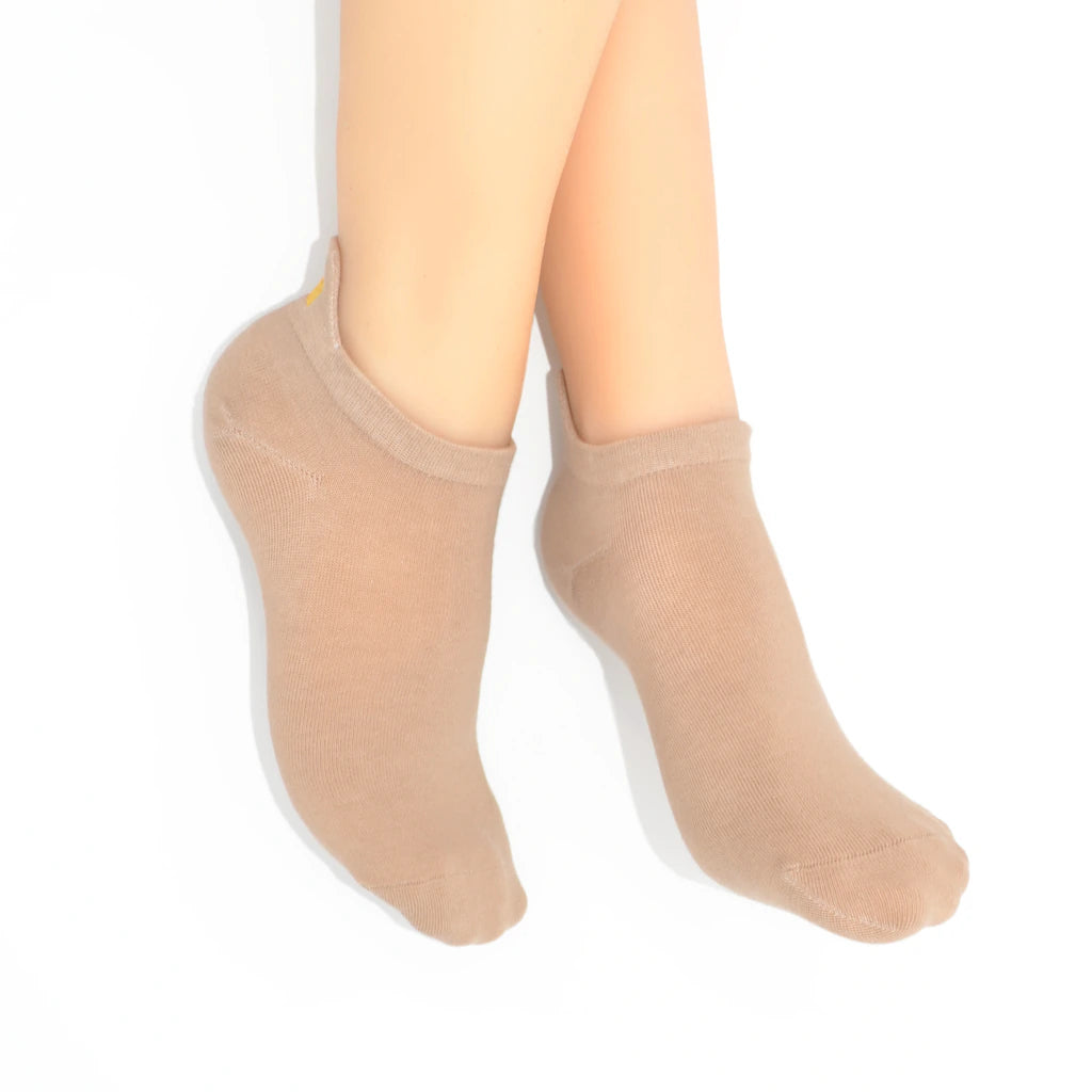legs showing beige no-show sock with an embroidered tab at the heel