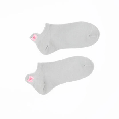 A pair of gray no-show socks with a embroidered tab at the heel in pink color.