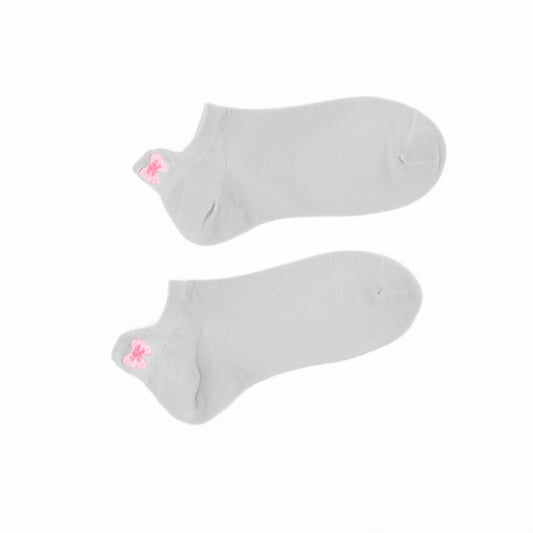 A pair of gray no-show socks with a embroidered tab at the heel in pink color.