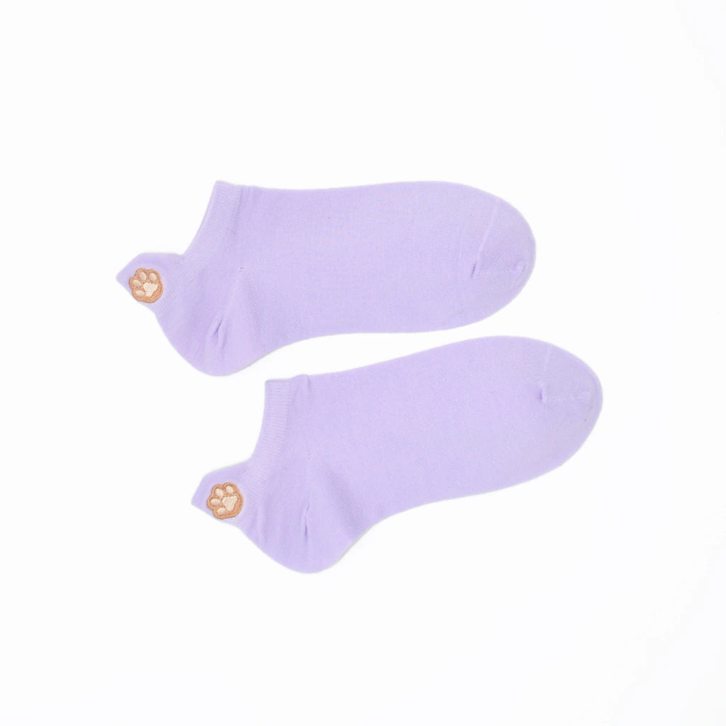 A pair of purple no-show socks with an embroidered paw print tab on the heel.