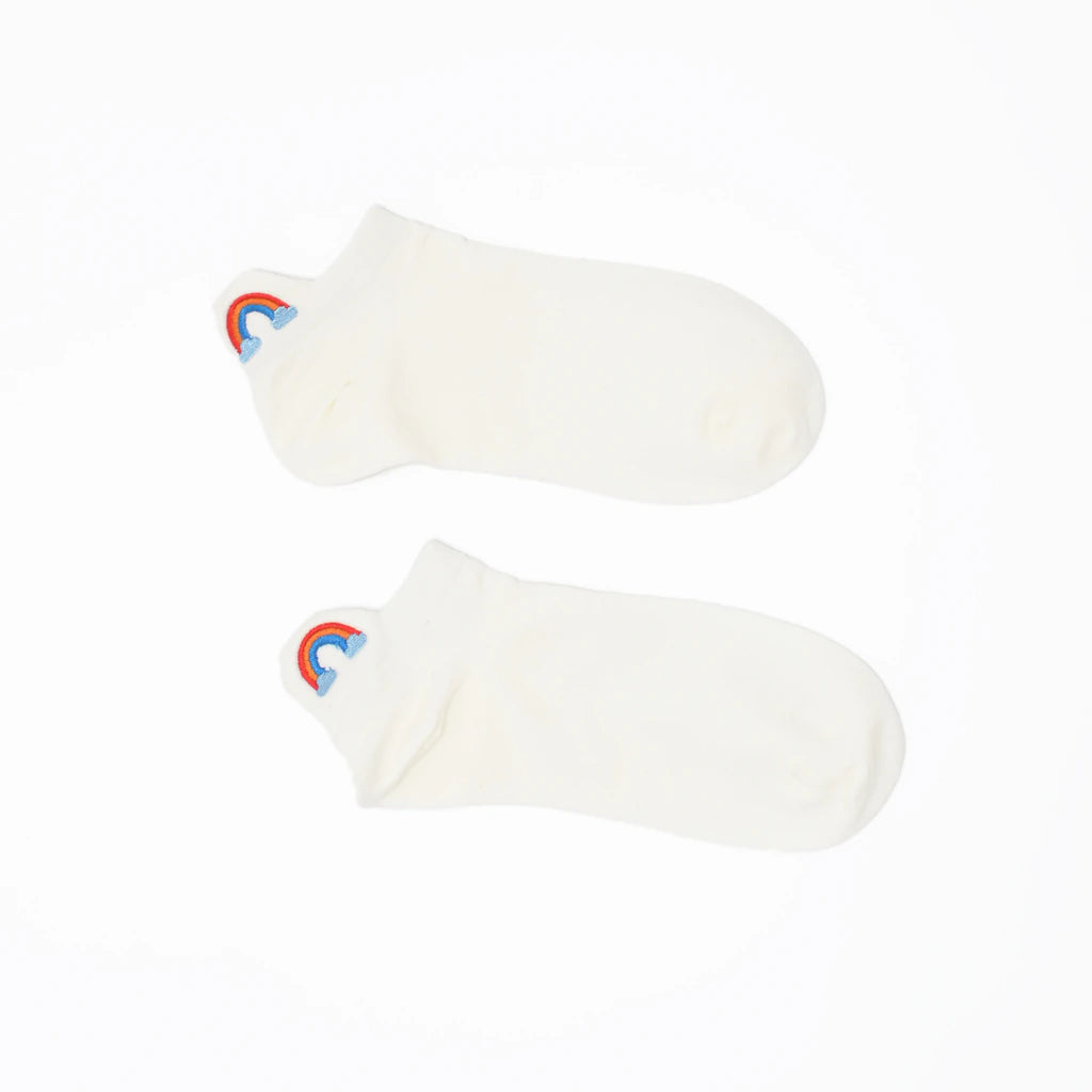 A pair of white no-show socks with an embroidered tab at the heel