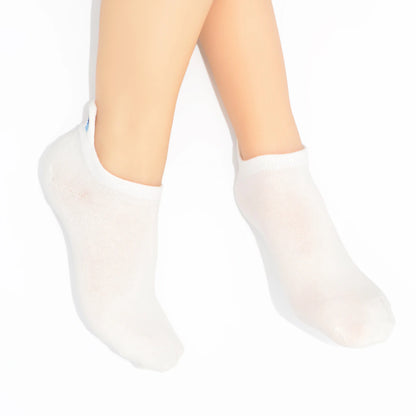 Legs modelling white no-show socks with an embroidered tab at the heel