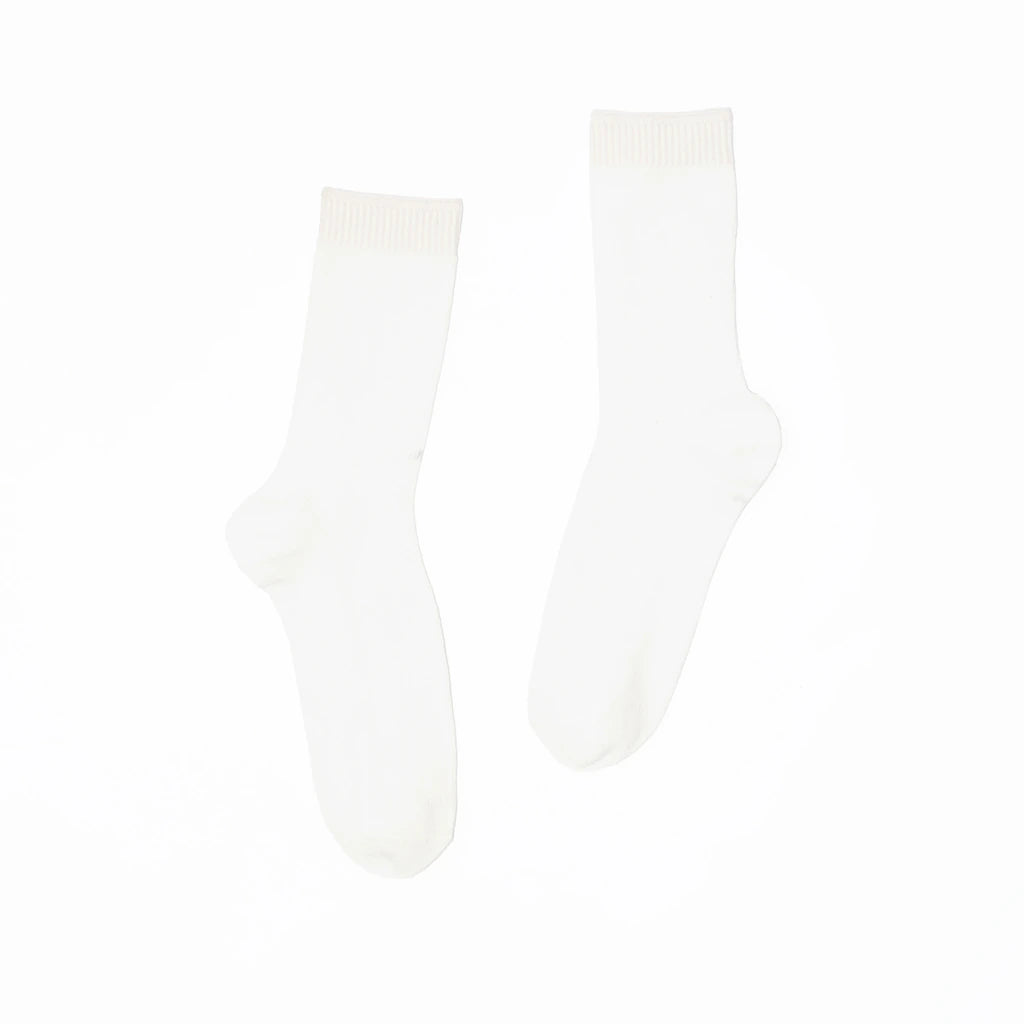 A pair of white socks on a white background