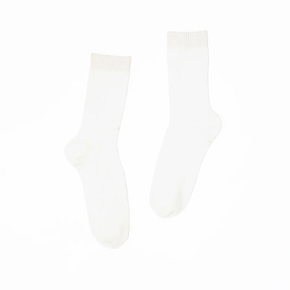 A pair of white socks on a white background