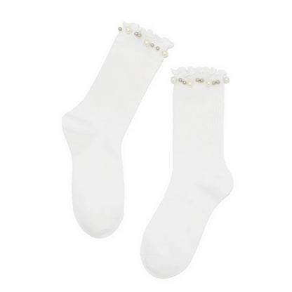 White socks with pearl embellishments on a white background