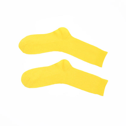 Two yellow socks on a white background