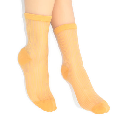 Yellow socks worn on a white background