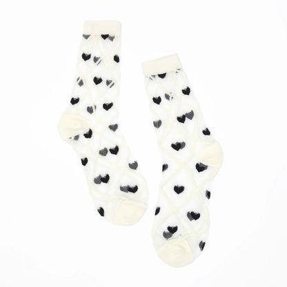 a pair of sheer mesh socks with black heart and white criss cross pattern