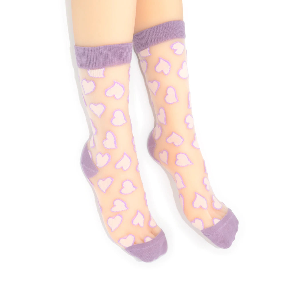 Sheer socks with heart pattern and purple accents worn by a person on a white background
